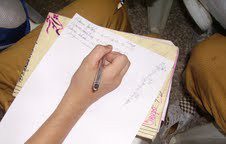 Participant recording data and observations on paper