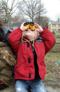 Sean on rocks searching for birds in the sky