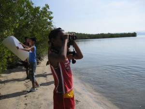 Participant observing birds by the bay