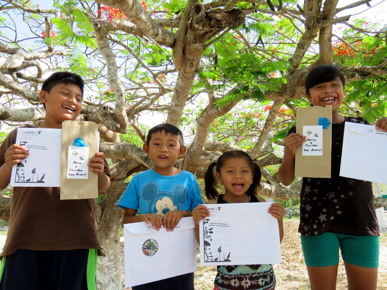 Kids hold their mini grant winner prizes